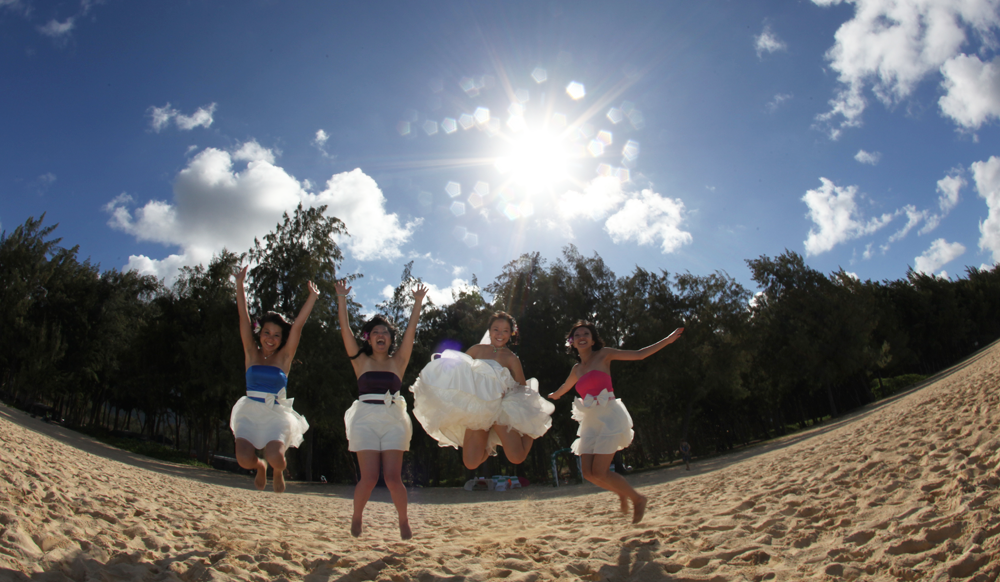 bride and bridesmaid jump in the air celebrating the love thats happening